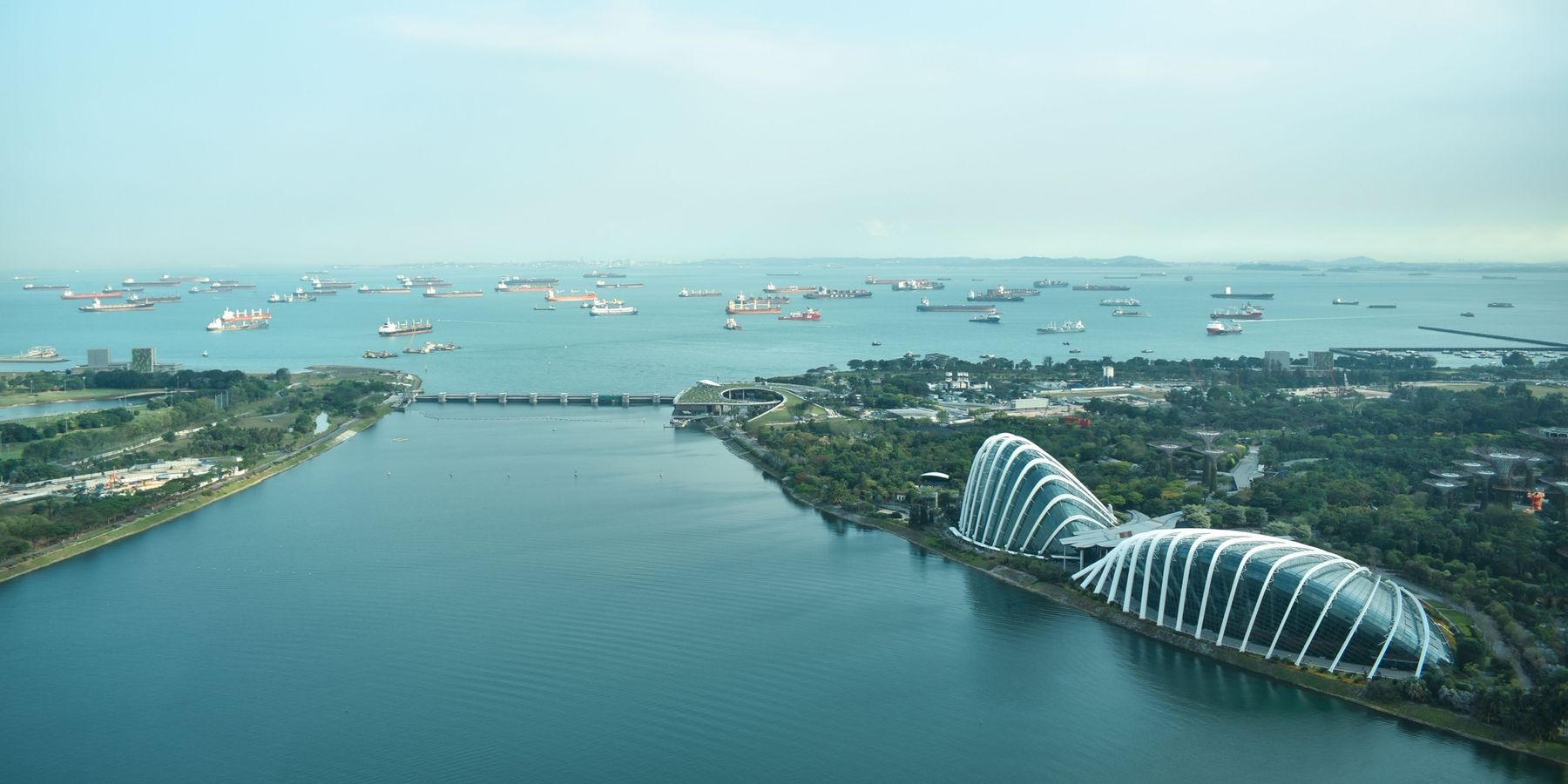 Aerial view of Marina Barrage and the garden domes with ships at sea